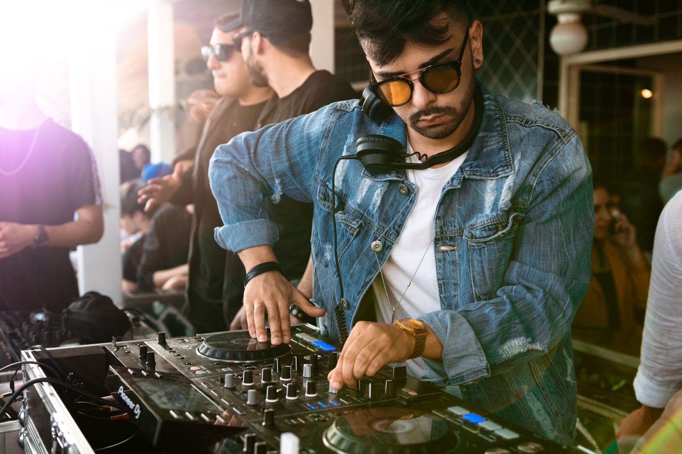 A DJ performing above the dance floor